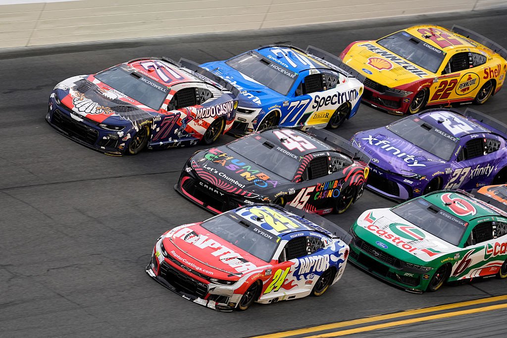 DAYTONA BEACH, FLORIDA - FEBRUARY 15: William Byron, driver of the #24 Raptor Chevrolet, Tyler Reddick, driver of the #45 Chumba Casino Toyota, and Michael McDowell, driver of the #71 Modo Casino Chevrolet, race during the NASCAR Cup Series Daytona 500 at Daytona International Speedway on February 15, 2026 in Daytona Beach, Florida. (Photo by Patrick McDermott/Getty Images)