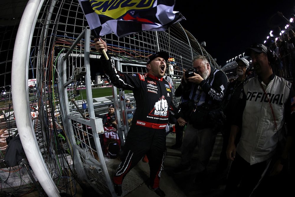 CONCORD, NORTH CAROLINA - OCTOBER 09: Layne Riggs, driver of the #34 BKB Bare Knuckle Boxing Ford, celebrates with the checkered flag after winning the NASCAR Craftsman Truck Series Ecosave 200 at Charlotte Motor Speedway on October 09, 2026 in Concord, North Carolina. (Photo by Jared C. Tilton/Getty Images)